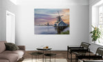 Uitgebreid canvas van Nederlandse windmolens bij een kleurrijke zonsondergang, formaat 180x120cm, in een stijlvol interieur.